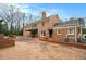 Brick backyard patio with lush landscaping, shade trees, and a serene, private outdoor area at 3074 Cascade Sw Rd, Atlanta, GA 30311