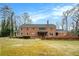 Spacious brick two-story home with a large backyard and an awning-covered patio for outdoor entertaining at 3074 Cascade Sw Rd, Atlanta, GA 30311