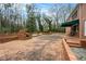 Large brick patio featuring an outdoor grill area, mature trees, and ample space for gatherings at 3074 Cascade Sw Rd, Atlanta, GA 30311