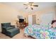 Bedroom featuring carpet, a chair and ottoman, desk with chair, and a bed with colorful linens at 3074 Cascade Sw Rd, Atlanta, GA 30311