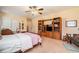 Bedroom featuring neutral carpet, a ceiling fan, and built-in shelving at 3074 Cascade Sw Rd, Atlanta, GA 30311