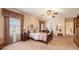 Bedroom featuring a ceiling fan, a cozy bed, and a window with decorative curtains at 3074 Cascade Sw Rd, Atlanta, GA 30311
