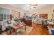 Spacious bedroom with hardwood floors, a ceiling fan, and multiple seating areas with an inviting, relaxed atmosphere at 3074 Cascade Sw Rd, Atlanta, GA 30311