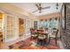 Charming dining area with large windows, French doors, a brick accent wall, and a ceiling fan at 3074 Cascade Sw Rd, Atlanta, GA 30311