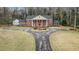 Aerial view of a stately brick home featuring a circular driveway and manicured landscaping at 3074 Cascade Sw Rd, Atlanta, GA 30311
