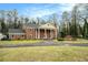 Traditional two-story brick home featuring a circular driveway and well-maintained landscaping at 3074 Cascade Sw Rd, Atlanta, GA 30311