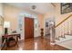 Bright foyer with a classic staircase, hardwood floors, and elegant entryway at 3074 Cascade Sw Rd, Atlanta, GA 30311