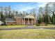 Inviting brick residence featuring a circular driveway, mature trees, and classic architectural details at 3074 Cascade Sw Rd, Atlanta, GA 30311