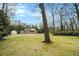 Classic two-story brick home with white columns, a circular driveway, and mature trees in a spacious front yard at 3074 Cascade Sw Rd, Atlanta, GA 30311
