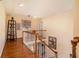 Upstairs hallway featuring wood floors, white railings, and neutral paint at 3074 Cascade Sw Rd, Atlanta, GA 30311