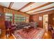 Living room with wood paneled walls, carpet and large windows at 3074 Cascade Sw Rd, Atlanta, GA 30311