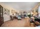 A sunlit living room with a piano, fireplace, and an array of artwork adorning the walls at 3074 Cascade Sw Rd, Atlanta, GA 30311