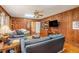 Living room featuring wood paneling, hardwood floors, and a built-in bookcase at 3074 Cascade Sw Rd, Atlanta, GA 30311