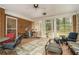 Enclosed porch features brick accents, tile flooring, and large windows offering backyard views at 3074 Cascade Sw Rd, Atlanta, GA 30311