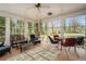Enclosed porch with tile flooring, ceiling fan, and views of lush greenery creating a peaceful retreat at 3074 Cascade Sw Rd, Atlanta, GA 30311