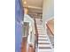 Inviting foyer features staircase with wood and iron railings and hardwood floors at 505 Tilbury Dr, Suwanee, GA 30024