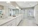 Luxury bathroom with double vanity, modern fixtures, white cabinets, and walk-in shower with glass surround at 55 Church St, Alpharetta, GA 30009