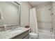 This bathroom features a granite countertop, a large mirror, and a shower with a tile surround at 55 Church St, Alpharetta, GA 30009