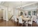 Open-concept dining and living room features dark wood floors and a chandelier at 55 Church St, Alpharetta, GA 30009