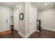 A detailed foyer with hardwood floors, a staircase, and entry to other rooms at 55 Church St, Alpharetta, GA 30009