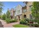 A row of beautifully designed townhouses showcases unique architectural details and lush landscaping at 55 Church St, Alpharetta, GA 30009