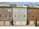 Charming townhome with a brick and painted facade and individual garages at 55 Church St, Alpharetta, GA 30009