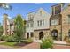 Attractive row of townhouses featuring brick and stone exteriors, complimented by professionally landscaped front lawns and brick driveways at 55 Church St, Alpharetta, GA 30009