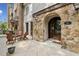 Inviting outdoor patio area perfect for relaxation, featuring stone accents, beautiful arched doorway, with comfortable seating arrangements at 55 Church St, Alpharetta, GA 30009
