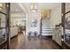 Elegant foyer with hardwood floors, chandelier, staircase, and seamlessly connected living spaces at 55 Church St, Alpharetta, GA 30009