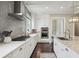 The kitchen features stainless appliances, white cabinets, gray backsplash, and a center island at 55 Church St, Alpharetta, GA 30009