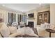 Bright, open living space featuring hardwood flooring, a fireplace, and large windows for natural light at 55 Church St, Alpharetta, GA 30009