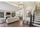Open-concept living area features hardwood floors, fireplace, TV, and seamless access to the dining and kitchen spaces at 55 Church St, Alpharetta, GA 30009