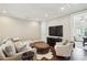 A cozy living room with plush seating, a large television, and hardwood floors at 55 Church St, Alpharetta, GA 30009