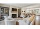 Inviting living room with a fireplace, hardwood floors, and plush seating, seamlessly flowing into an open-concept dining and kitchen area at 55 Church St, Alpharetta, GA 30009