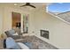 Cozy covered patio featuring comfortable seating, a fireplace, and an outdoor ceiling fan at 55 Church St, Alpharetta, GA 30009