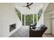 Outdoor covered patio with a fireplace, ceiling fan, and wicker seating at 55 Church St, Alpharetta, GA 30009