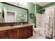 Bathroom featuring green walls, a granite countertop vanity, and a shower with a curtain at 5641 Roswell Rd # 307, Sandy Springs, GA 30342