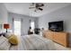 Bedroom with neutral paint, ceiling fan, desk, and dresser at 5641 Roswell Rd # 307, Sandy Springs, GA 30342