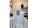 Laundry room with washer, dryer, shelving, and tiled floor at 5641 Roswell Rd # 307, Sandy Springs, GA 30342