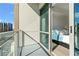 Cozy balcony with glass railings offering a glimpse of the adjacent bedroom at 1100 Howell Mill Nw Rd # 613, Atlanta, GA 30318