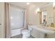Well-lit bathroom featuring a pedestal sink, subway tile shower, and classic fixtures at 1100 Howell Mill Nw Rd # 613, Atlanta, GA 30318