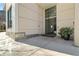Condo building entrance with glass doors, address signage, and decorative plants at 1100 Howell Mill Nw Rd # 613, Atlanta, GA 30318