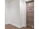 Hallway with neutral carpet, white walls, and a brown condo unit door marked 