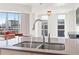 Modern kitchen island with a sleek faucet and a view of the city at 1100 Howell Mill Nw Rd # 613, Atlanta, GA 30318