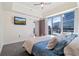 Cozy main bedroom with city views, a ceiling fan, and a television at 1100 Howell Mill Nw Rd # 613, Atlanta, GA 30318