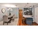 Bright dining area with a modern chandelier and a view into the stylish kitchen at 214 Ridley Howard Ct, Decatur, GA 30030