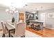 Open concept dining area and kitchen with stainless steel appliances and hardwood floors at 214 Ridley Howard Ct, Decatur, GA 30030