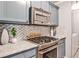 Modern kitchen with granite countertops, stainless steel appliances, and decorative backsplash at 214 Ridley Howard Ct, Decatur, GA 30030