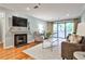 Bright living room with fireplace, balcony, hardwood floors, and comfortable seating at 214 Ridley Howard Ct, Decatur, GA 30030