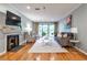 Bright living room with fireplace, balcony, hardwood floors, and comfortable seating at 214 Ridley Howard Ct, Decatur, GA 30030